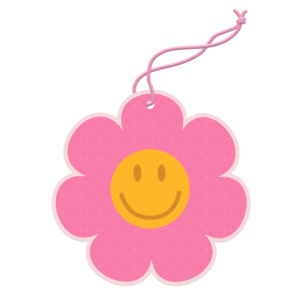 Air freshener of a pink flower with the center of it being a yellow smiley face. 