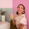 Girl holding a funky checkered pattern glass cup.