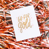 White greeting card with gold text 