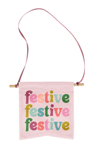 small flag with phrase festive festive festive in multi-color letters with pink background.