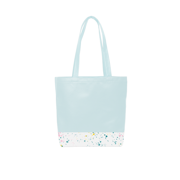 A cute tote bag with long shoulder strap in a powder blue with white paint splatter detail along the bottom.