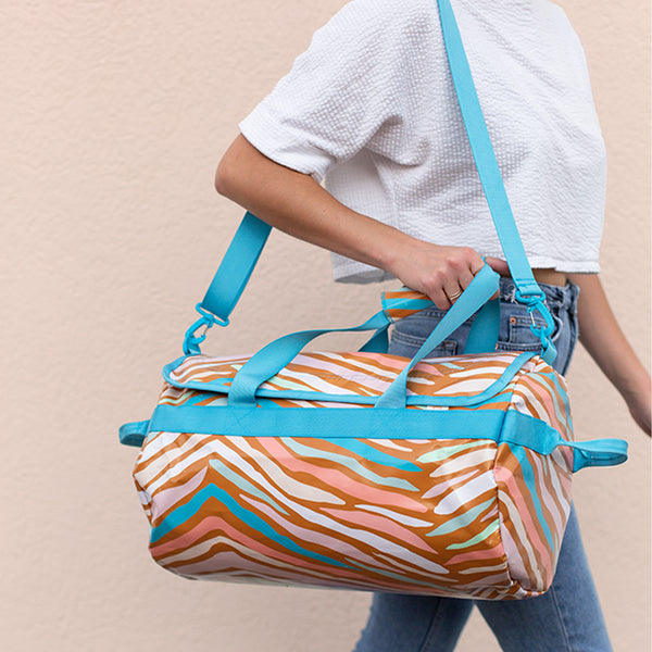 Girl walking with the Wild Stripe patterned traveler over her shoulder.