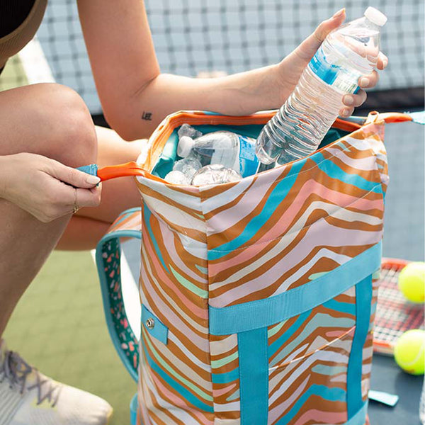 A wild-striped back pack in neutral and pastel colors. Also has blue accent straps to the front and back of the bag.