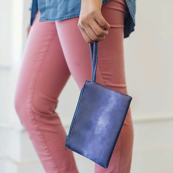 Girl holding a cute wristlet in Indigo Dreams navy blue pattern.