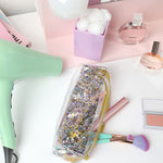 a cute lifestyle shot of a confetti jitterbug next to a mint colored hairdryer, pink books, and a lilac cup