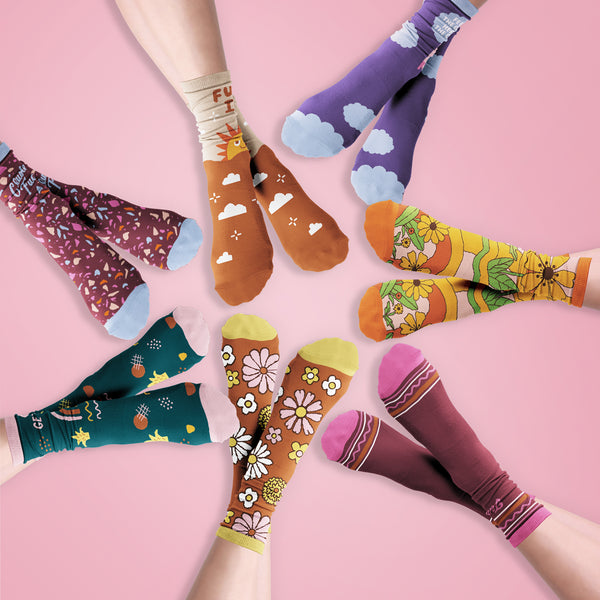 Cute sassy socks on crossed feet arranged in a circle