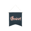 Thrive Wallflower is a cute canvas wall hanging in navy blue with pink lettering.