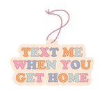 Air freshener with "Text Me When You Get Home" written in orange, baby blue, pink, and blue on it.