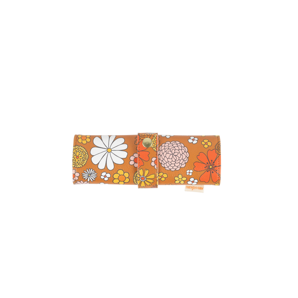 Small TOOTsie roll pouch in vegan leather in groovy brown floral pattern closed with strap and snap closure