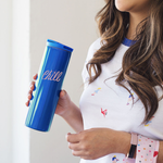 A woman holding a royal blue stainless steel tumbler that reads "Chill" in light pink text. 