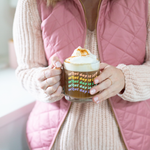 a girl holding a cute glass mug that says what day is it