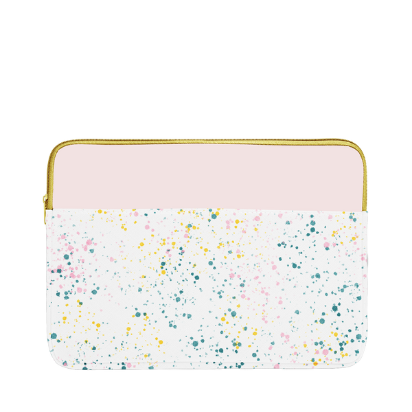 White paint splatter print laptop sleeve with blush pink trim, a gold zipper, and 13 inch size.