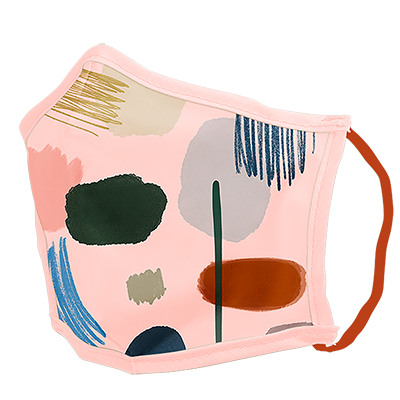 A pink facemask with paintbrush marks in nurtural and natural themed colors. 