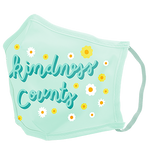 A blue facemask with small daisies. In the middle in blue cursive written "kindness counts." 