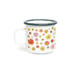 A white campfire mug with yellow, orange, coral, yellow, pink and white flowers spread all around the mug.