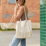 All That Grocery tote with leather handles. Chill hills pattern in metallic gold on all sides of the bag. 