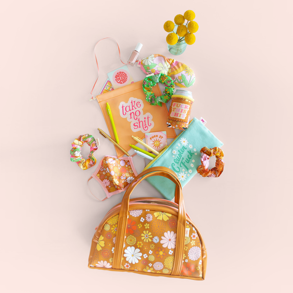 group of flowered gift items spilling out of a floral bag with sayings "take no shit", "cluster fuck" and "fuck this shit" -- Cluster Fuck