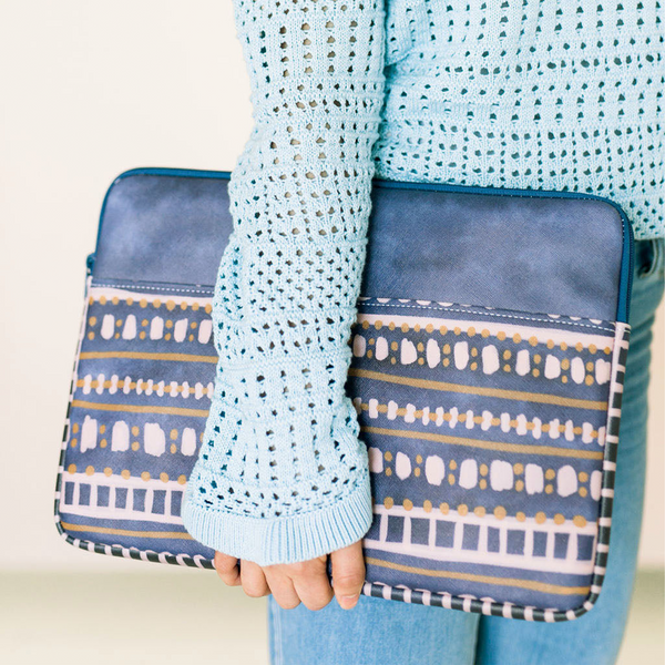 Girl in a blue sweater holding a cute laptop sleeve in Boho Dress pattern.