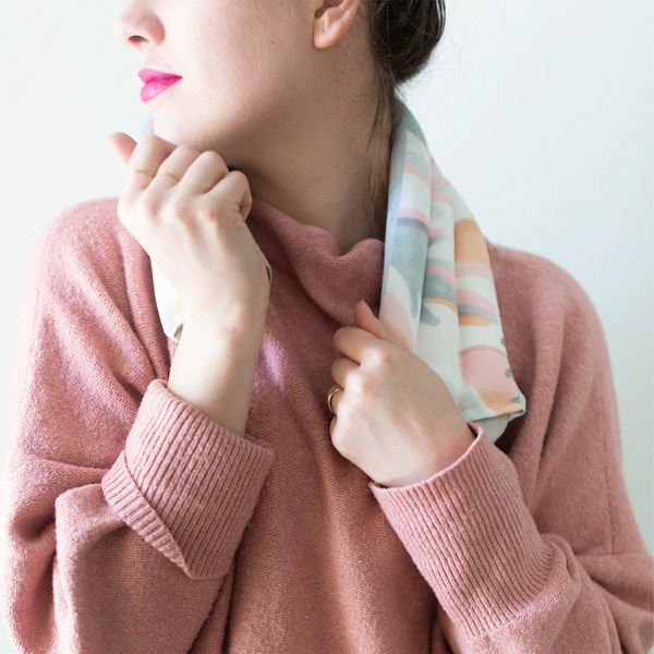 a girl wearing A weighted neck wrap with mutey fruity print