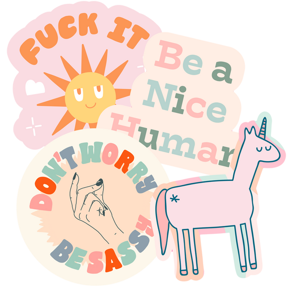 A "Fuck it" sticker, "Be a nice human", "Don't worry be sassy" and a Unicorn sticker. All multicolored.