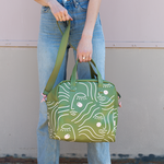 A lady holding the Zen Ladies skate bag.