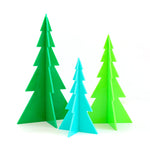 three acrylic trees one large in green, one medium in light green and one in small blue.