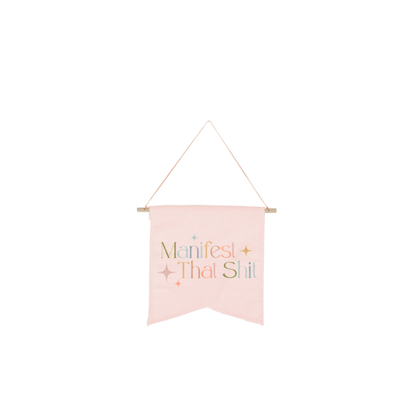 Light pink colored hanging wallflower with "Manifest That Shit" printed in multiple colors