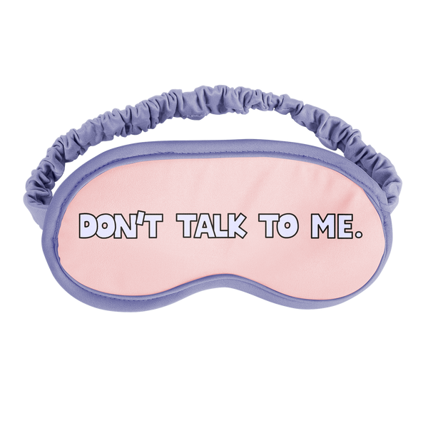 A sleep mask with periwinkle outline and strap that says don't talk to me 