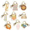 An assortment of 9 Talking Out Of Turn enamel key charms.