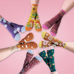 Cute sassy socks on crossed feet arranged in a circle