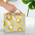 A girl holding the medium light violet and green checker pattern with flowers soulmate on a white surface, green plant in the background