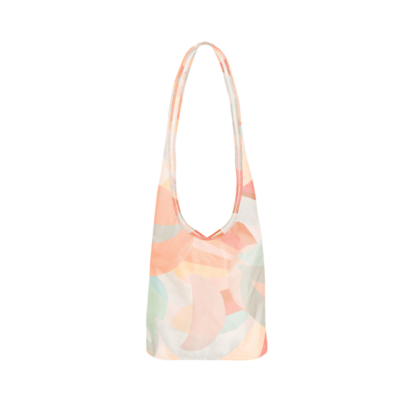 A tote bag with pastel pinks, greens, blues, and reds. Design on bag is multiple moons, overlapping each other. 